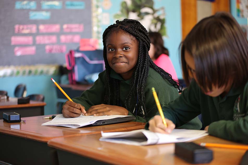 students and teacher working in classroom