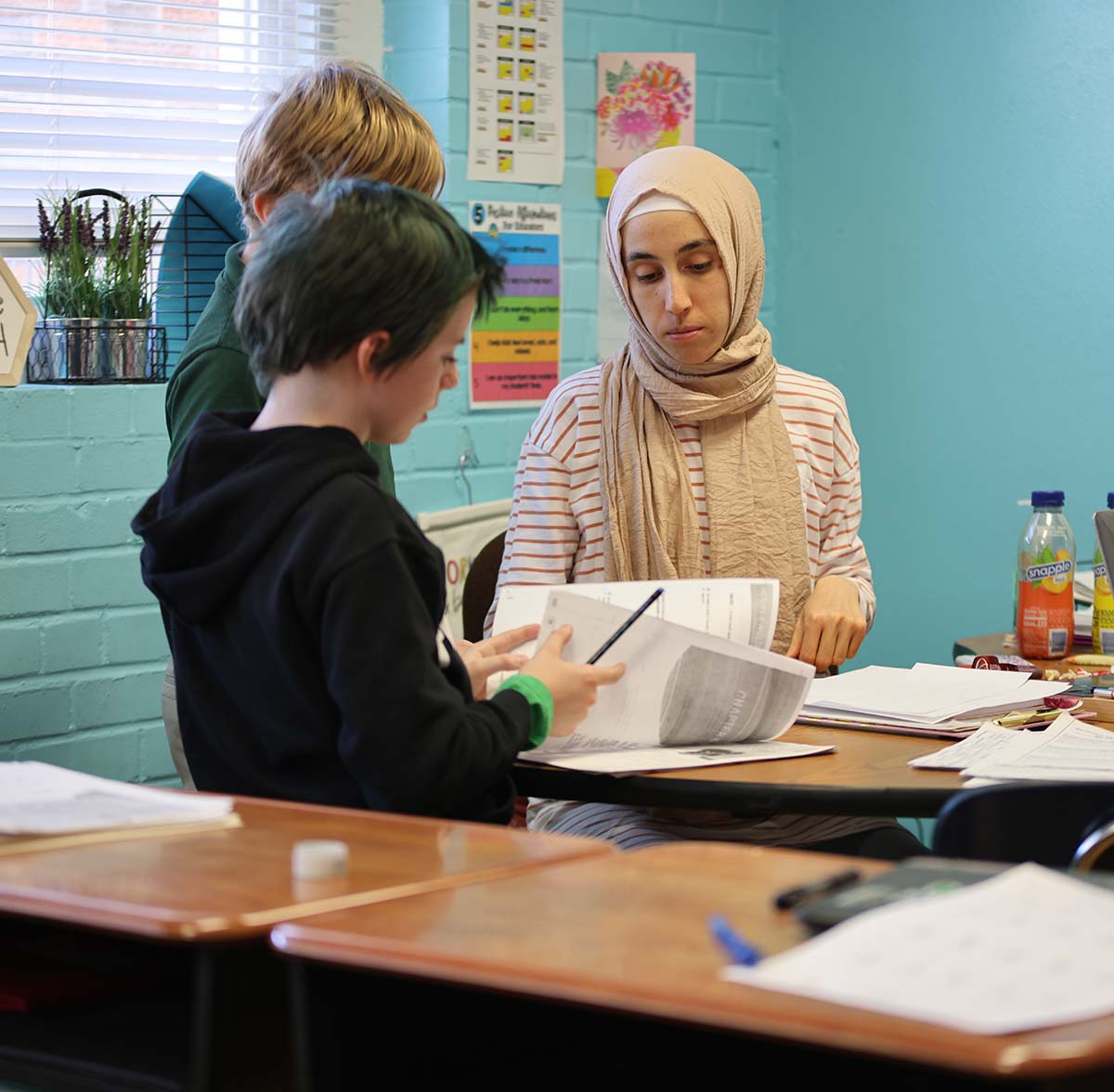 GSA St. Louis Smiley Teacher and student interacting at a classroom desk