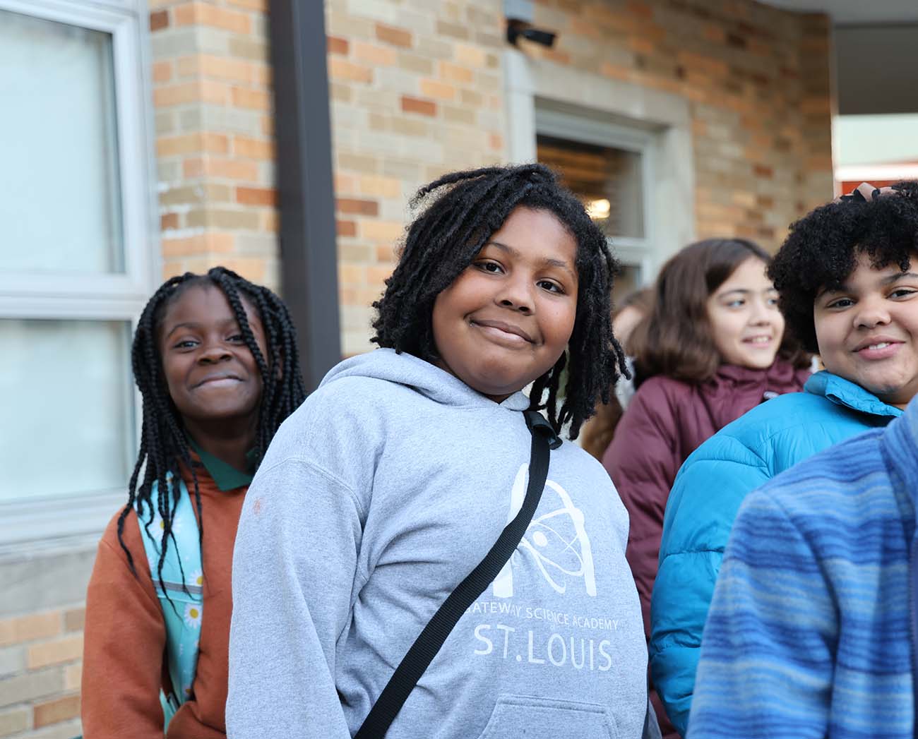 Smiling children together outdoors.